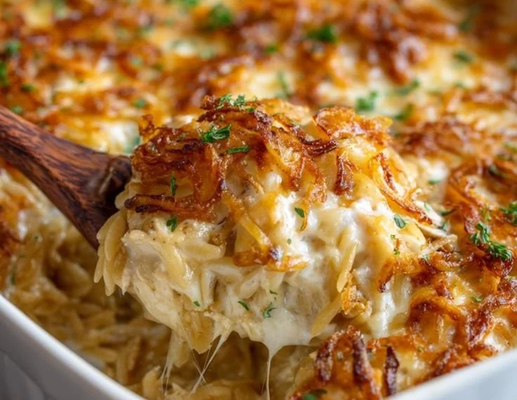 Delicious French Onion Chicken Orzo Casserole topped with melted cheese