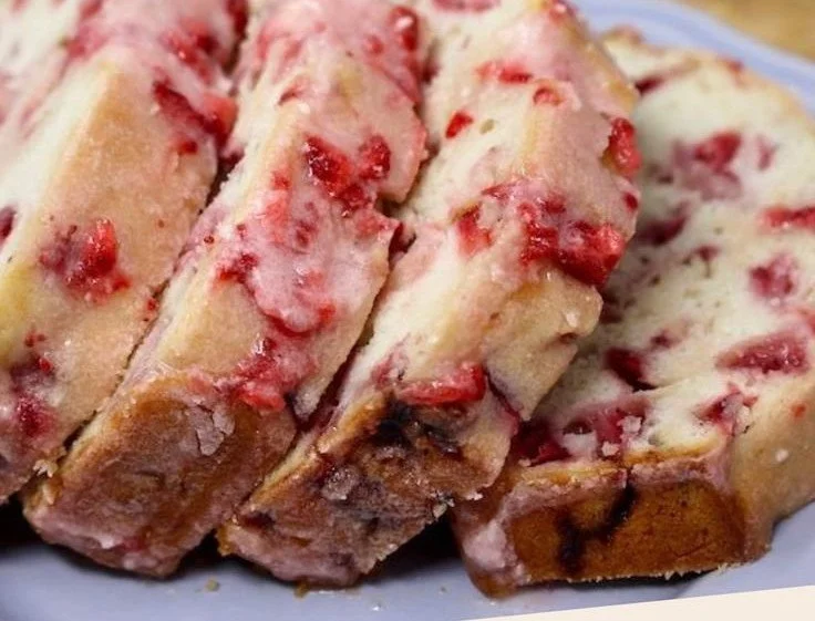 Delicious glazed strawberry bread loaf with fresh strawberries on top