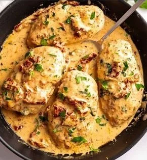 Delicious Marry Me Chicken recipe served on a plate with fresh herbs.