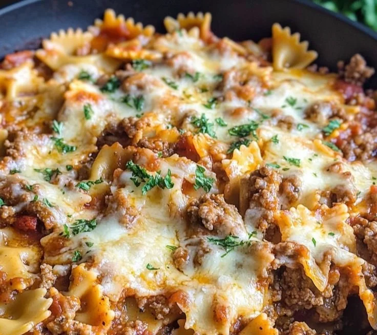One pot skillet lasagna cooking in a cast iron pan with rich layers of cheese and sauce