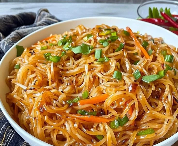 Rice Noodle Stir-Fry Colorful rice noodle stir-fry with vegetables in a skillet