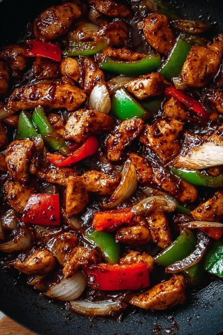 Savory black pepper chicken dish with vegetables and rice