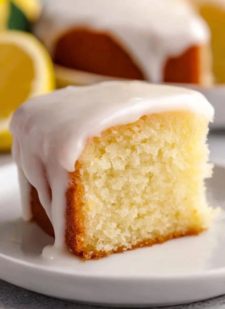 Lemonade Cake A slice of Lemonade Cake with a lemon garnish on a plate